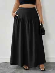 Black ribbed maxi skirt with pockets and an A-line cut.