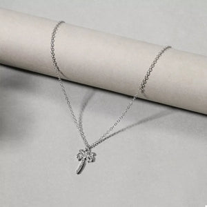 Silver palm tree pendant necklace with pave crystals on a delicate chain.