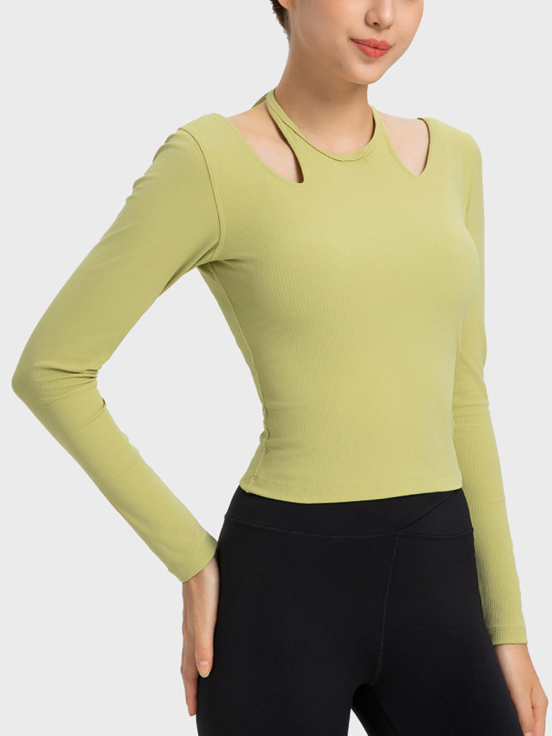 Yellow-green ribbed long sleeve active top with cutout shoulders and a choker neckline.
