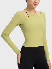 Yellow-green ribbed long sleeve active top with cutout shoulders and a choker neckline.