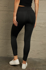 Black performance leggings with knee slits and a comfortable fit.
