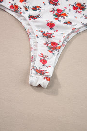 White floral bustier camisole with ruffle trim and thong bottom detail.