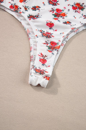 White floral bustier camisole with ruffle trim and thong bottom detail.