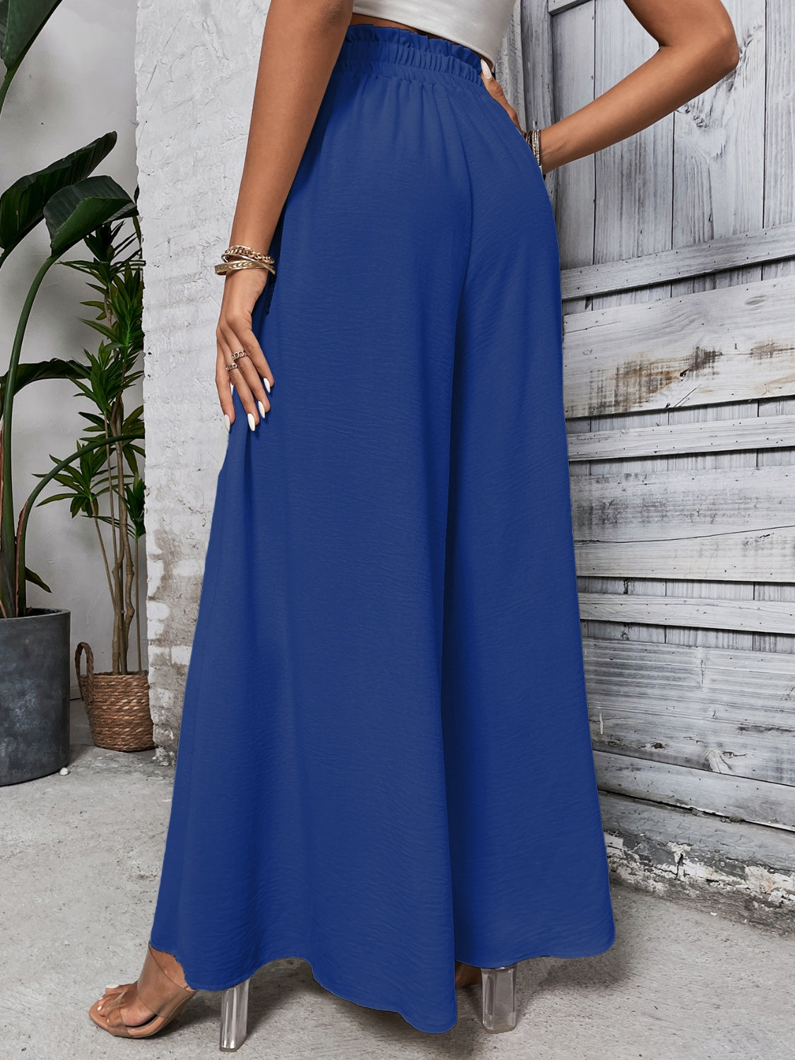 Royal blue ruffled waistline palazzo trousers with wide legs.