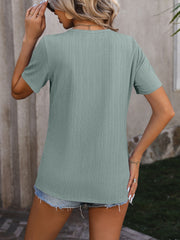 Sage green textured tee with short sleeves and split hem detail.