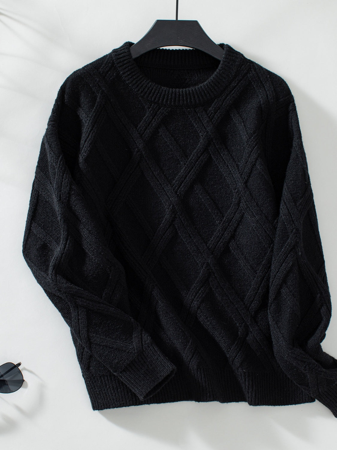 Black diamond cable knit crewneck sweater with ribbed cuffs and hem.
