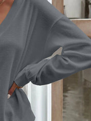 Dark gray waffle knit button-down cardigan with long sleeves and a relaxed fit.