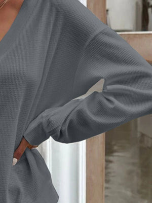 Dark gray waffle knit button-down cardigan with long sleeves and a relaxed fit.