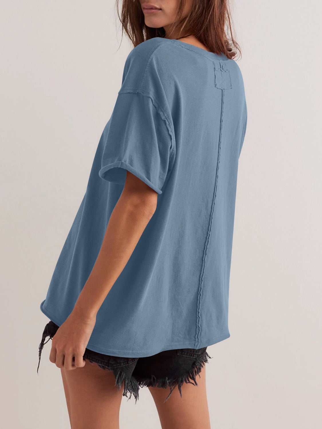 Dusty blue cotton oversized tee with seam detail and raw hem sleeves.