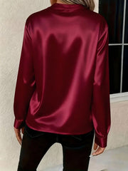 Burgundy satin blouse with long sleeves and a notched neckline, shown from the back.
