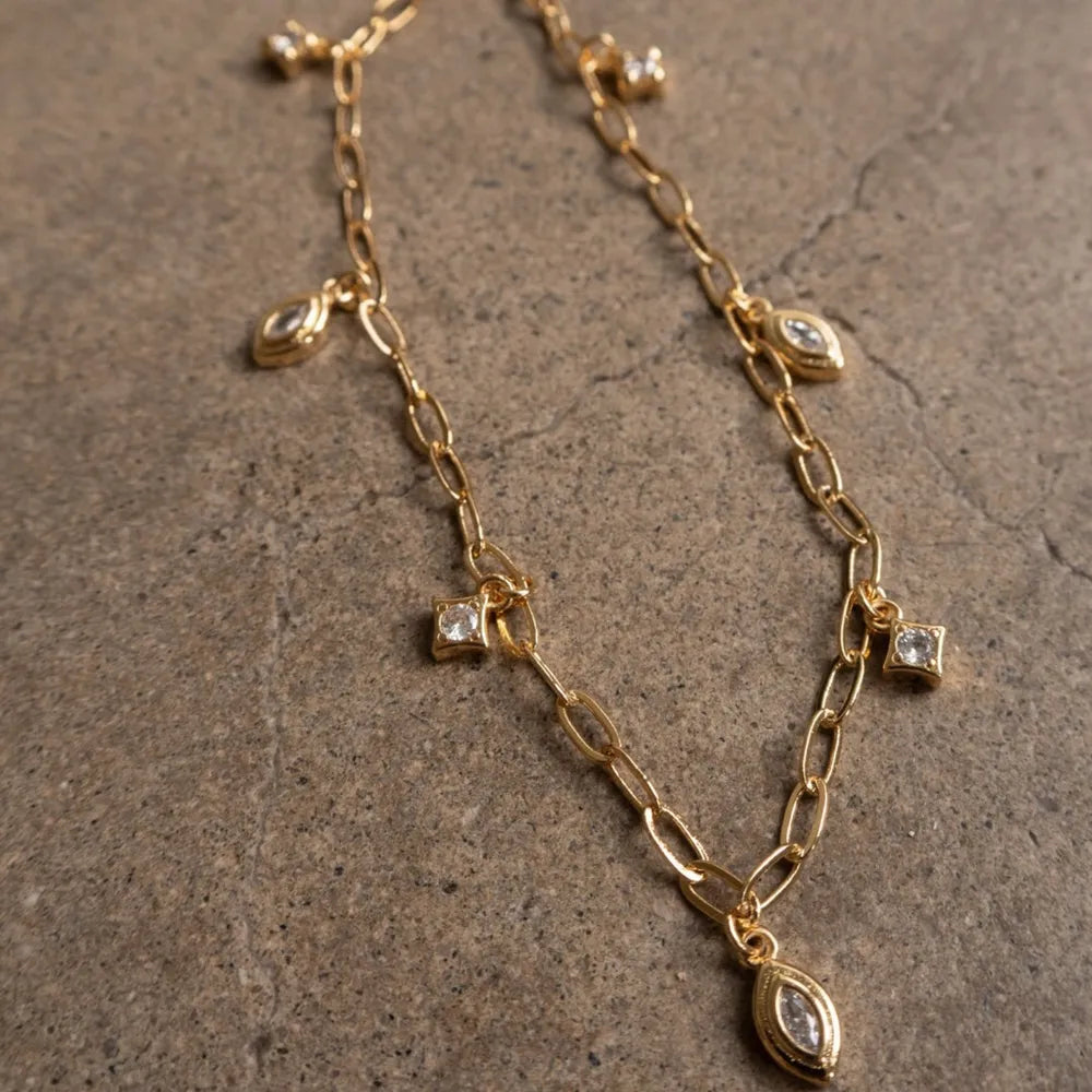 Gold curb chain necklace with marquise and square cubic zirconia charms