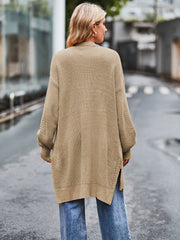 Open-stitch waffle knit duster cardigan in camel with side slits and open knit sleeves.