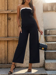 Black bicolor bandeau palazzo jumpsuit with wide legs and a white trim neckline.
