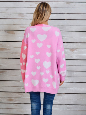 Pink and hot pink split-panel cardigan with allover white hearts and pockets.