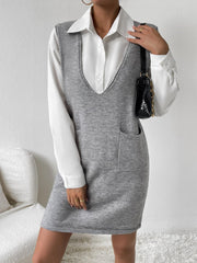 Sleeveless grey knit mini dress with V-neck and patch pockets, worn over a white collared shirt.