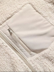 Beige sherpa zip-up jacket with a chest patch pocket and zipper details.
