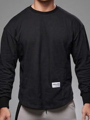 Black oversized long sleeve tee with curved hem and crew neck.