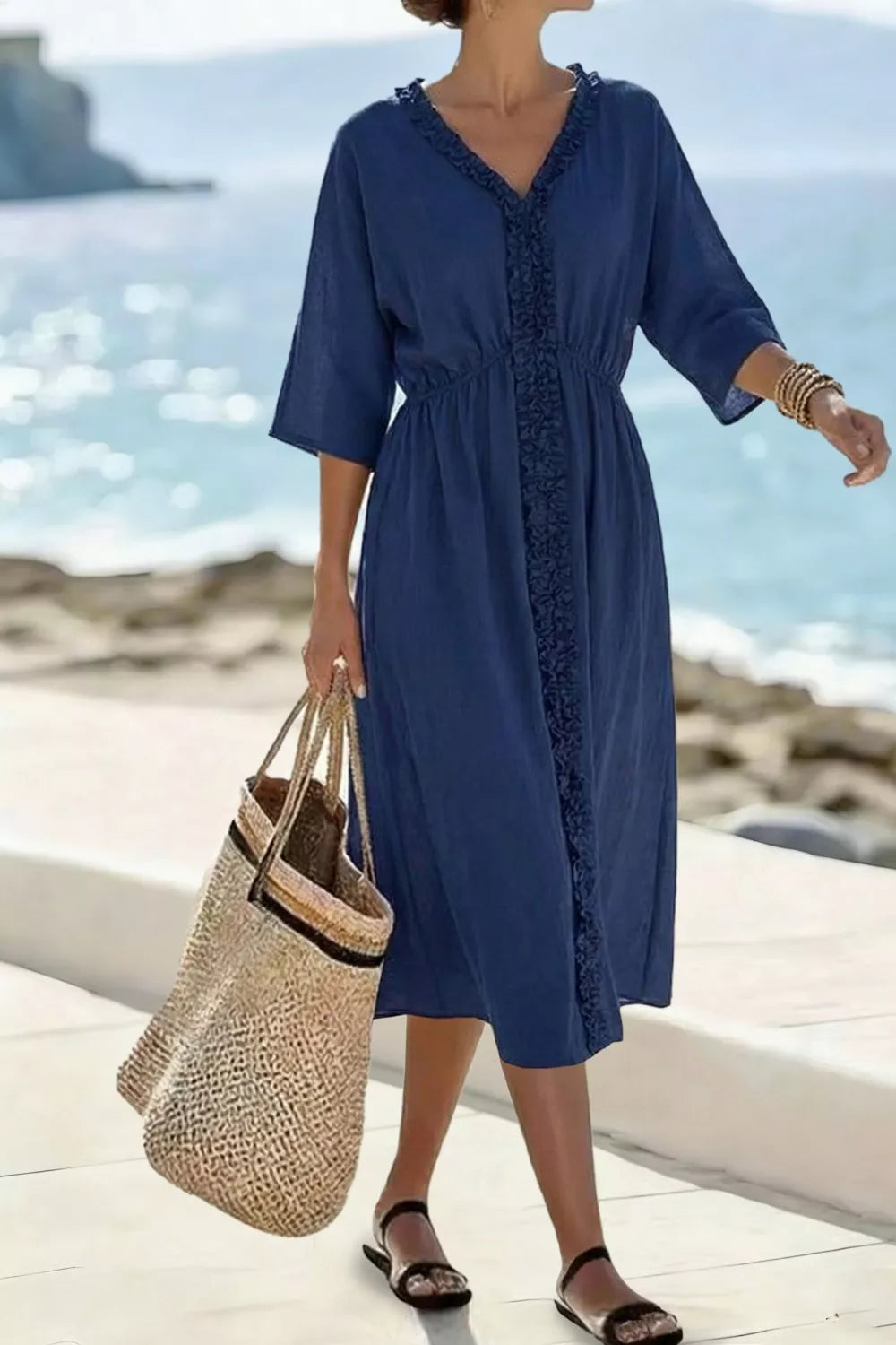 Blue ruffled v-neck midi dress with elastic waist and 3/4 sleeves.