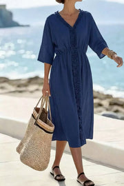 Blue ruffled v-neck midi dress with elastic waist and 3/4 sleeves.
