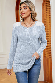 Light blue ribbed knit top with eyelet shoulder detail and crew neck.