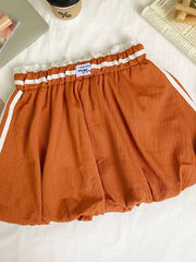 Orange mini skirt with white stripes, lace trim, and gathered waist.