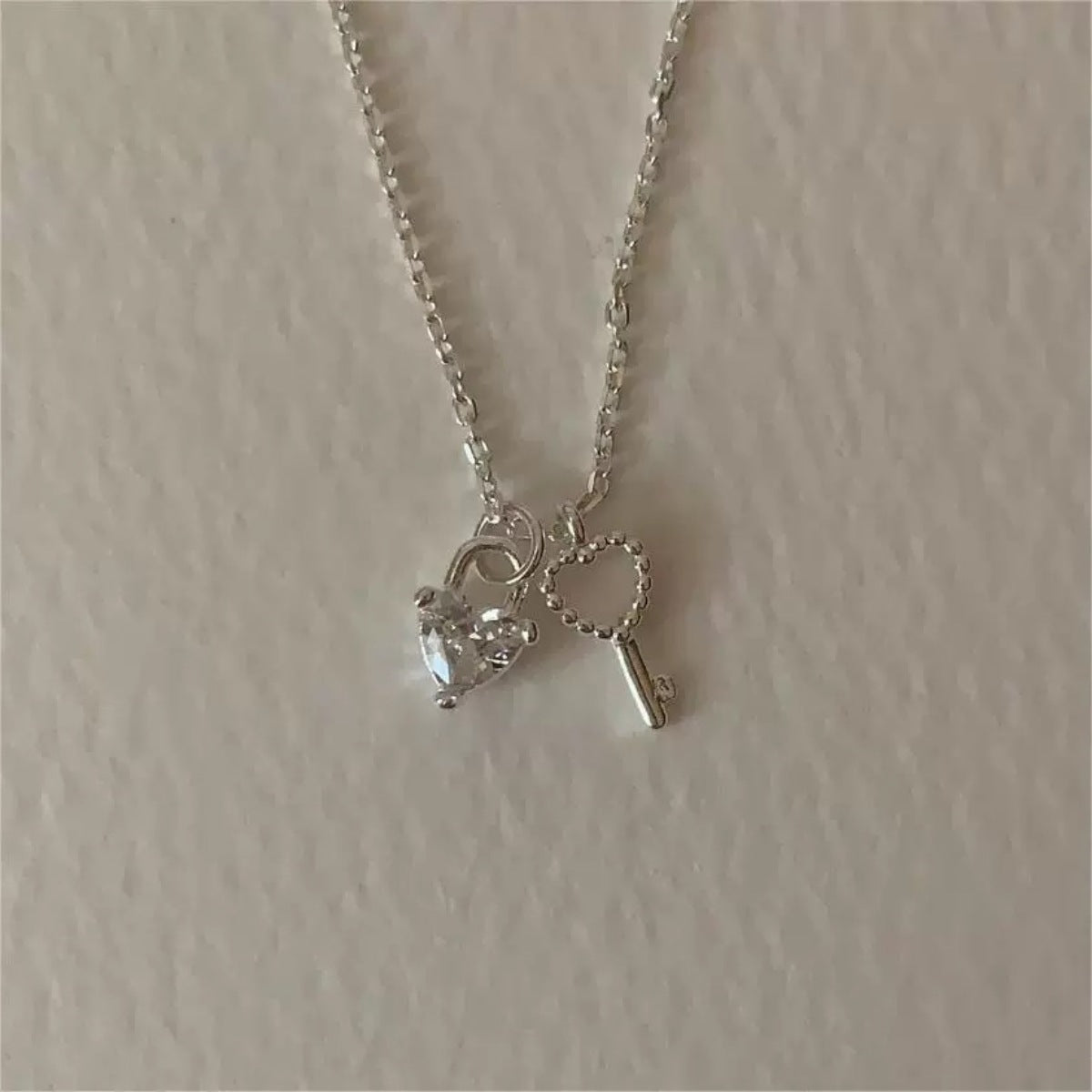 Sterling silver necklace with heart lock charm and key charm