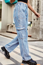 Light wash denim cargo pants with relaxed fit and multiple pockets.