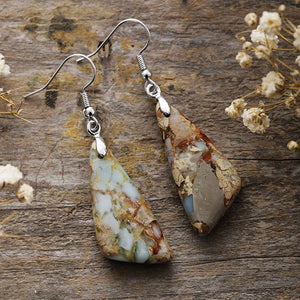 Multicolor stone drop earrings with silver hooks and unique earthy patterns.