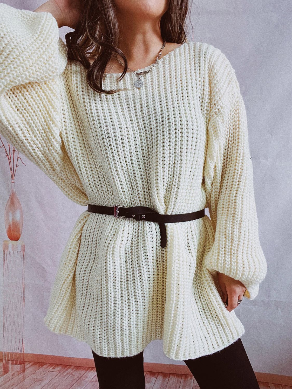 Oversized cream ribbed knit sweater with belted waist, long sleeves, and crew neck.