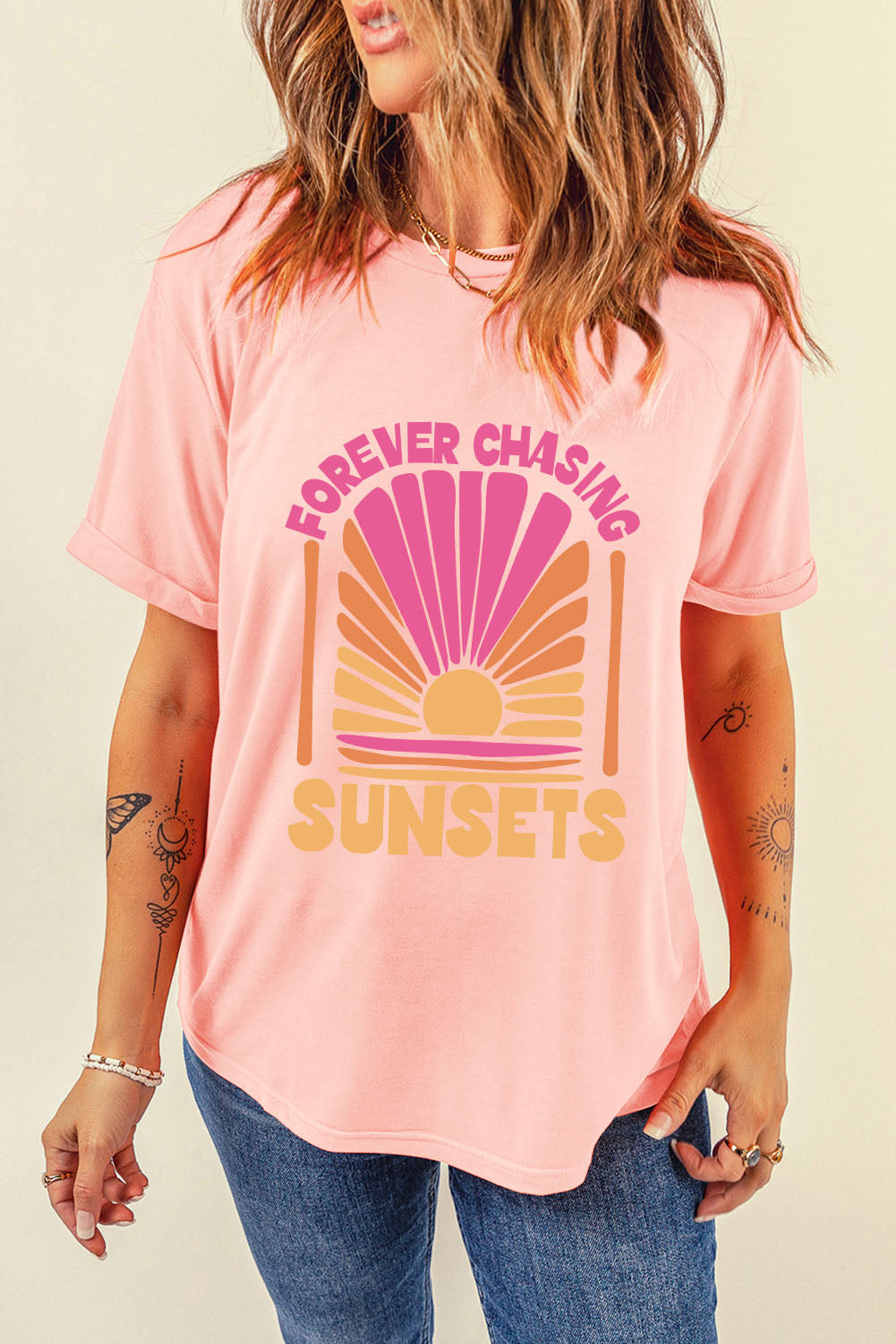 Watermelon pink graphic tee with a sunset design and text that reads "Forever Chasing Sunsets".