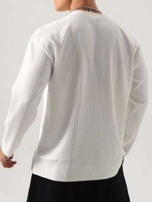 White textured plissé long sleeve henley top with a ribbed finish.