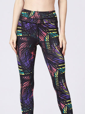 Black leggings with a colorful palm leaf print and stirrup detail.