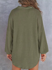 Army green waffle-knit Henley tee with buttoned collar and long sleeves.