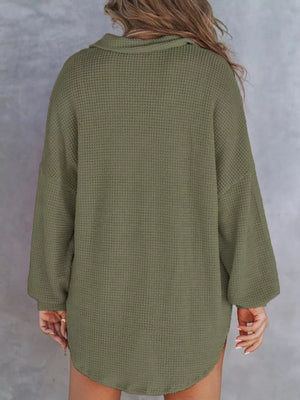 Army green waffle-knit Henley tee with buttoned collar and long sleeves.