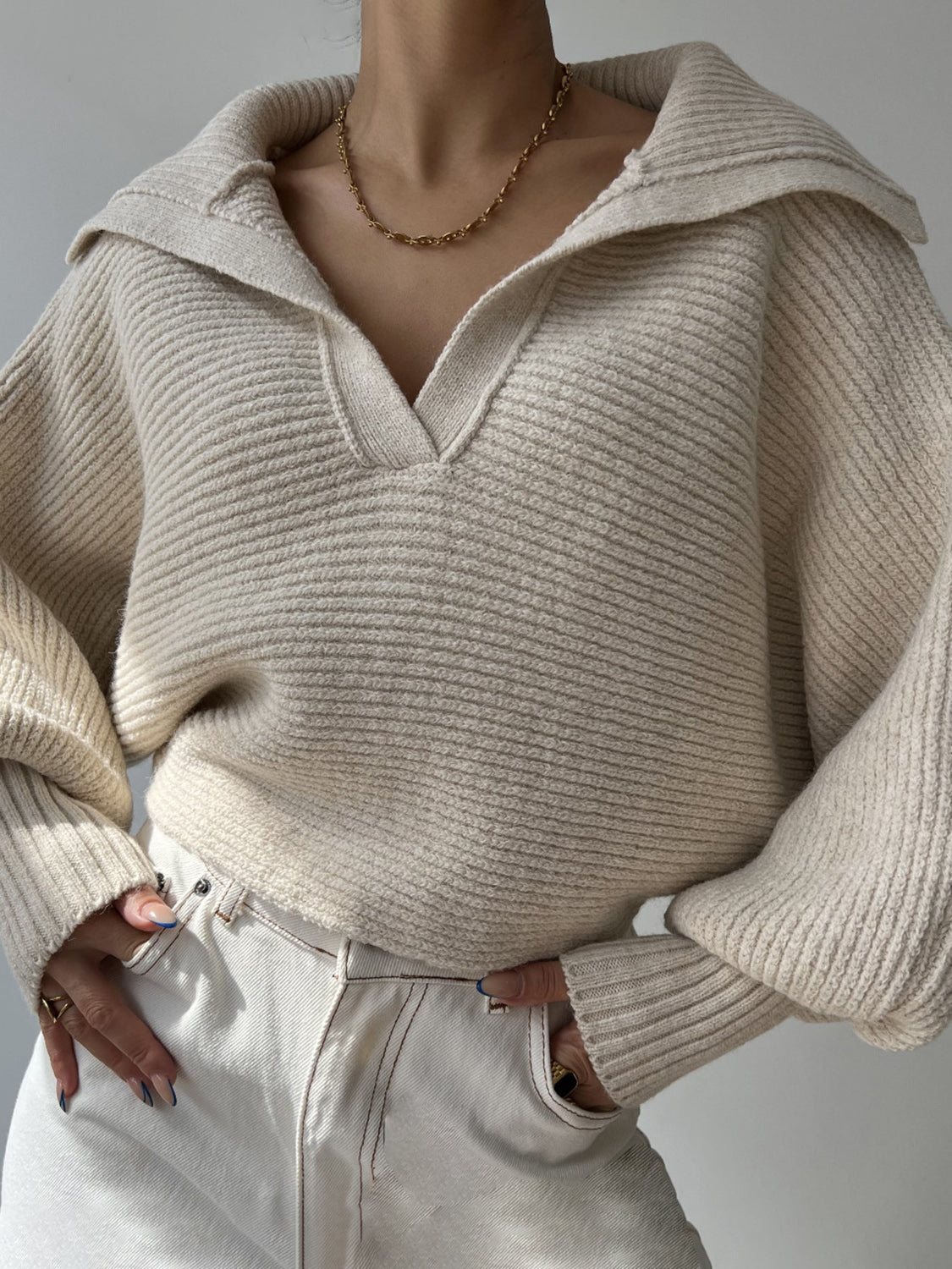 Wide collar balloon sleeve knit sweater in white with a v-neck and ribbed texture.