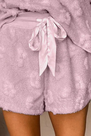 Textured blush pink lounge shorts with adjustable satin tie and fuzzy heart pattern.