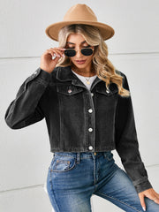 Black cropped denim trucker jacket with button front and chest pockets.