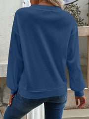 Blue waffle knit button-down cardigan with long sleeves and a crew neckline.
