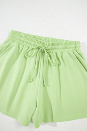 Lime cotton lounge shorts with elastic waistband and drawstring.