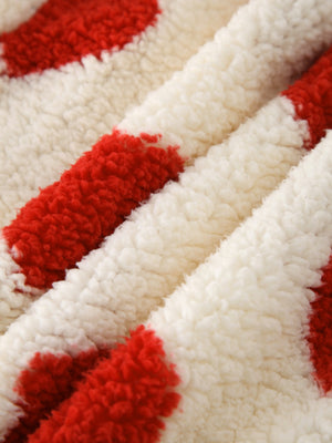 Heart print sherpa hoodie in cream with red hearts, showing fuzzy texture.