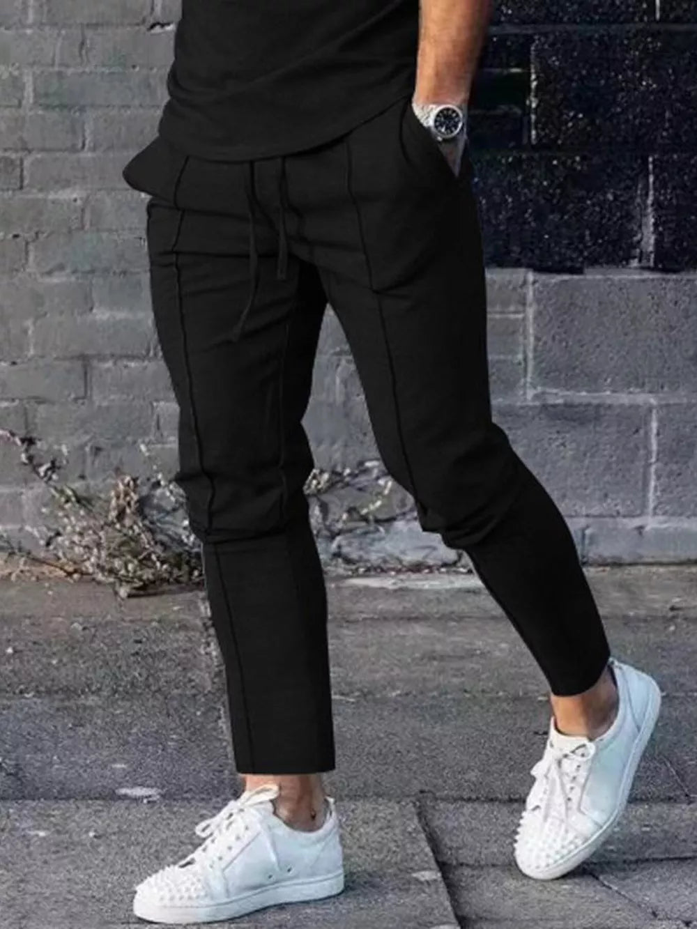 Black casual drawstring sweatpants with pockets and ankle cuffs.