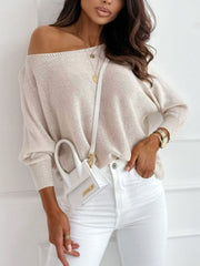 Cream off-shoulder batwing knit sweater with boatneck and bow back detail.