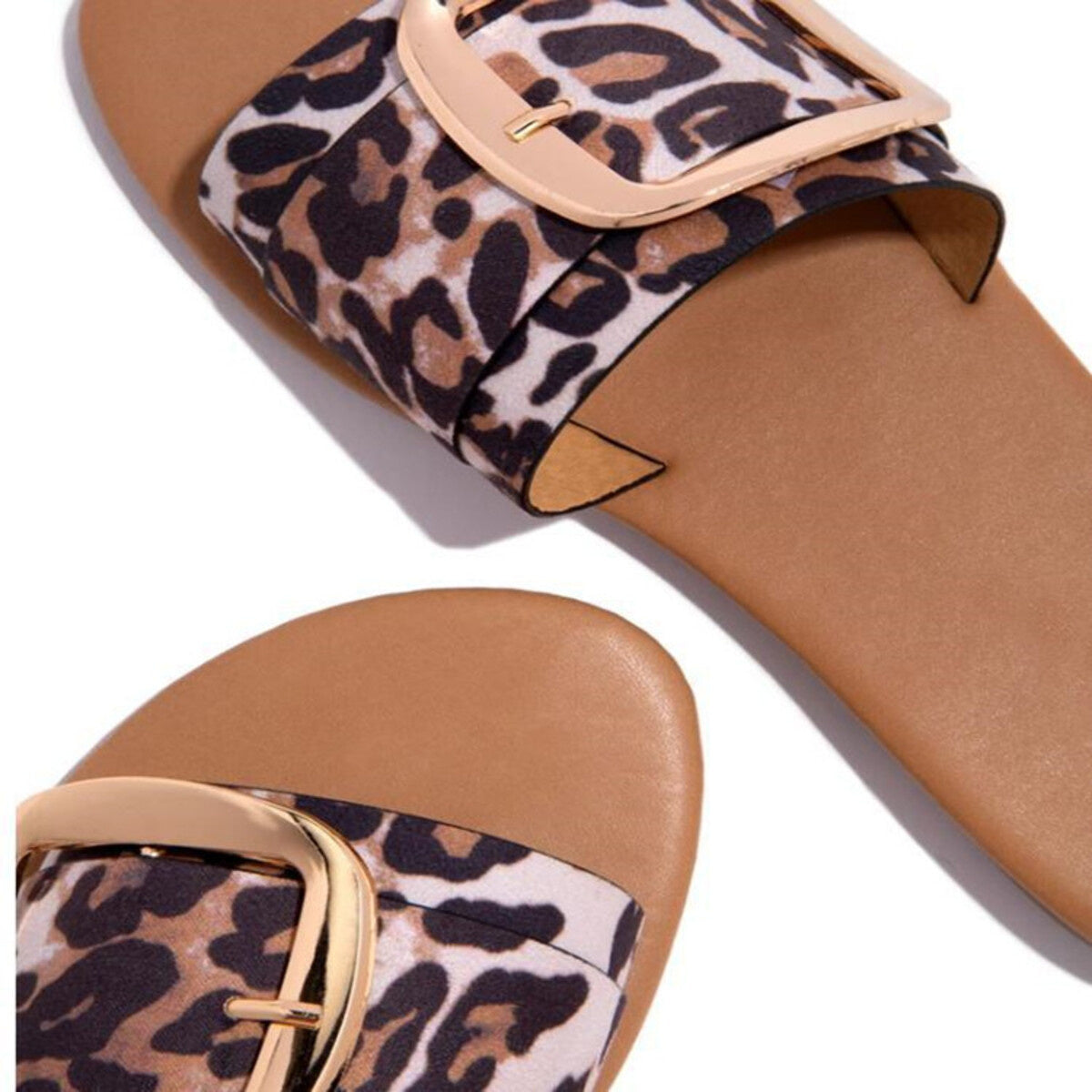 Leopard print slide sandals with gold buckle detail and open toe.