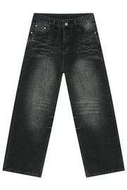 Dark wash denim jeans with a distressed, oversized wide-leg silhouette and cat's whisker detailing.