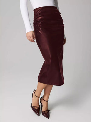 Burgundy faux leather midi skirt with ruched detail and body-con fit.