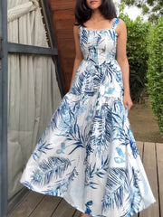 Lace-trimmed tropical leaf maxi dress with blue and white pattern, square neckline and tiered skirt.