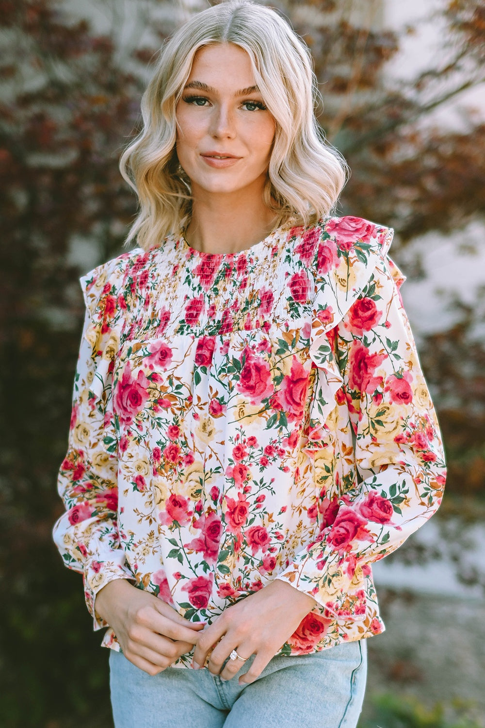 Multicolor floral ruffle smocked yoke blouse with long sleeves.