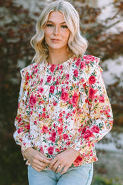 Multicolor floral ruffle smocked yoke blouse with long sleeves.
