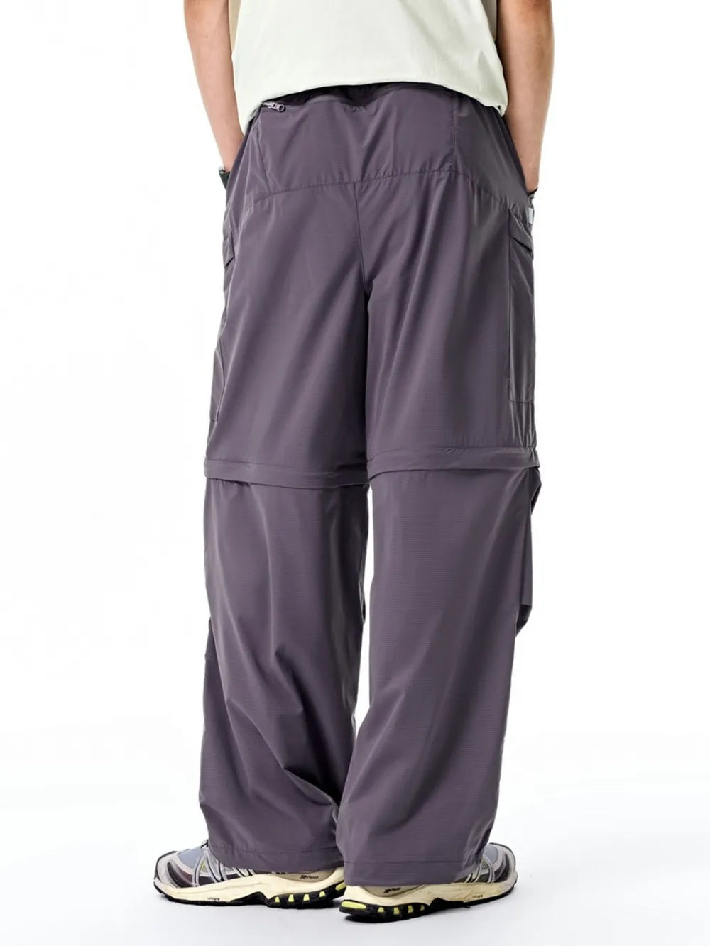 Gray cargo pants with zip-off legs and adjustable drawstring waist.
