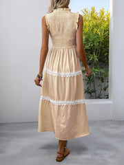 Yellow striped midi dress with smocked bodice, tiered skirt, and lace trim.